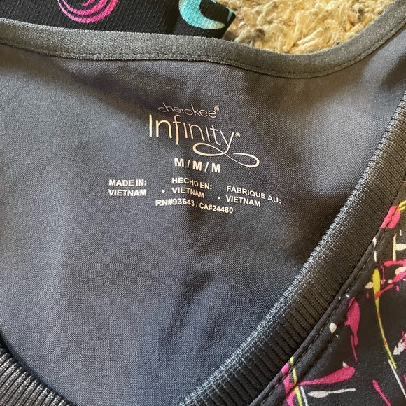 Scrub tops, like new. Sizes on pics, $20 each or all 3 for $50. - Picture 2 of 4